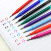 A collection of eight colored retractable gel pens arranged diagonally on lined paper.