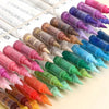 A collection of soft acrylic paint markers in various shades of pink, purple, blue, and green arranged on a white background.