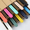 A box filled with various colored silicone sport bands for an Apple Watch, arranged in rows.