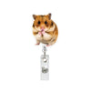 A fluffy brown hamster is attached to a clear acrylic badge reel with a retractable clip.