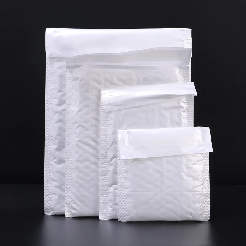 A stack of white self-sealing pearl film bubble shipping bags.