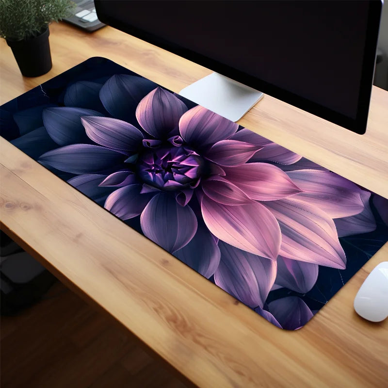 A floral mouse pad featuring a purple and pink peony design placed on a wooden desk.