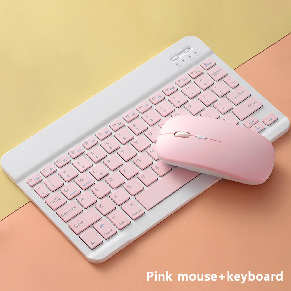 A pink wireless mouse and keyboard set placed on a light orange surface.