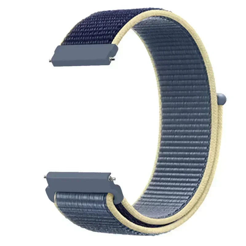 A close-up view of a navy blue nylon loop watch strap with a light beige edge and silver buckles.