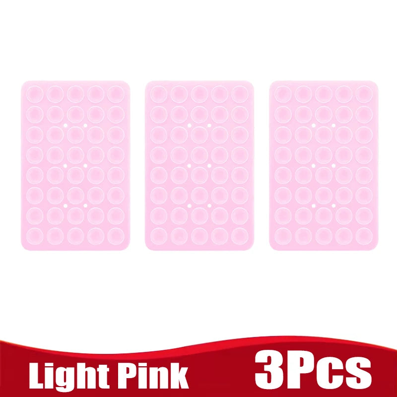 Three light pink silicone suction cup phone holders for mounting devices