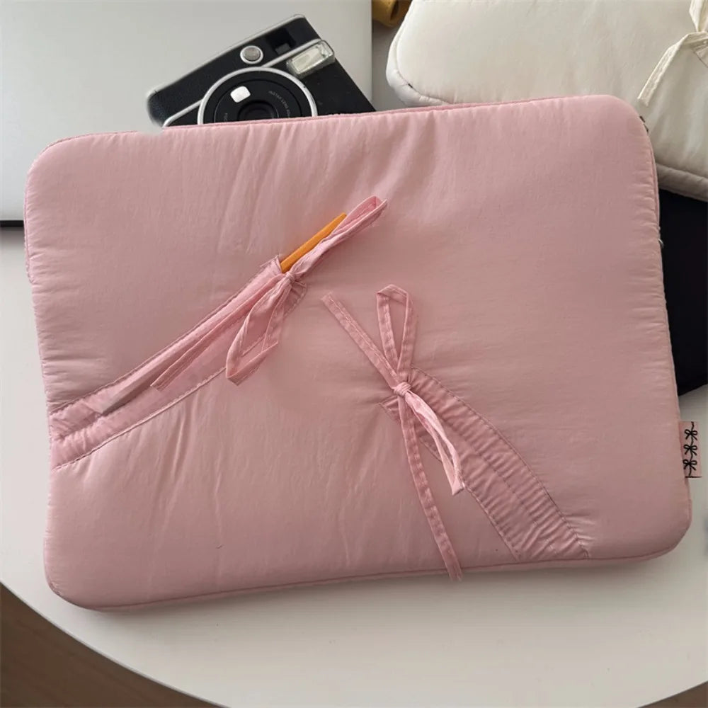 A soft pink ultra-thin laptop sleeve case for tablets and notebooks with pink drawstrings.