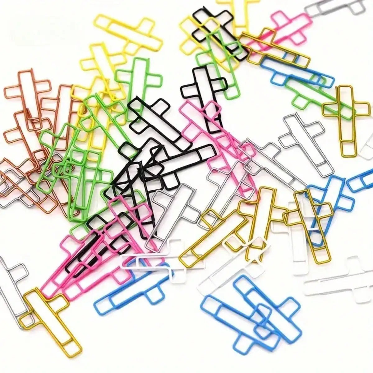 A collection of cross-shaped metal paper clips in various colors including yellow, green, pink, black, and blue.
