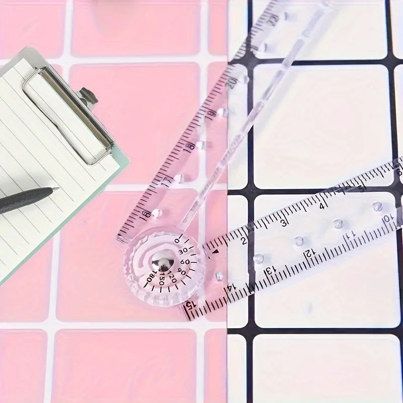 Regla plegable de acrílico transparente junto a un fondo de cuadrícula rosa.