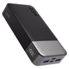 A black portable power bank with a silver base showing a 100% charge indicator.