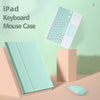 A light mint green iPad keyboard case with a detachable Bluetooth keyboard and a matching mouse case displayed on a wooden su