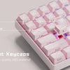 Translucent pink jelly keycaps set made from PC and ABS materials shown on a keyboard.