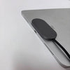 A gray iPad is shown with a black magnetic wireless charging adapter connected to its side.