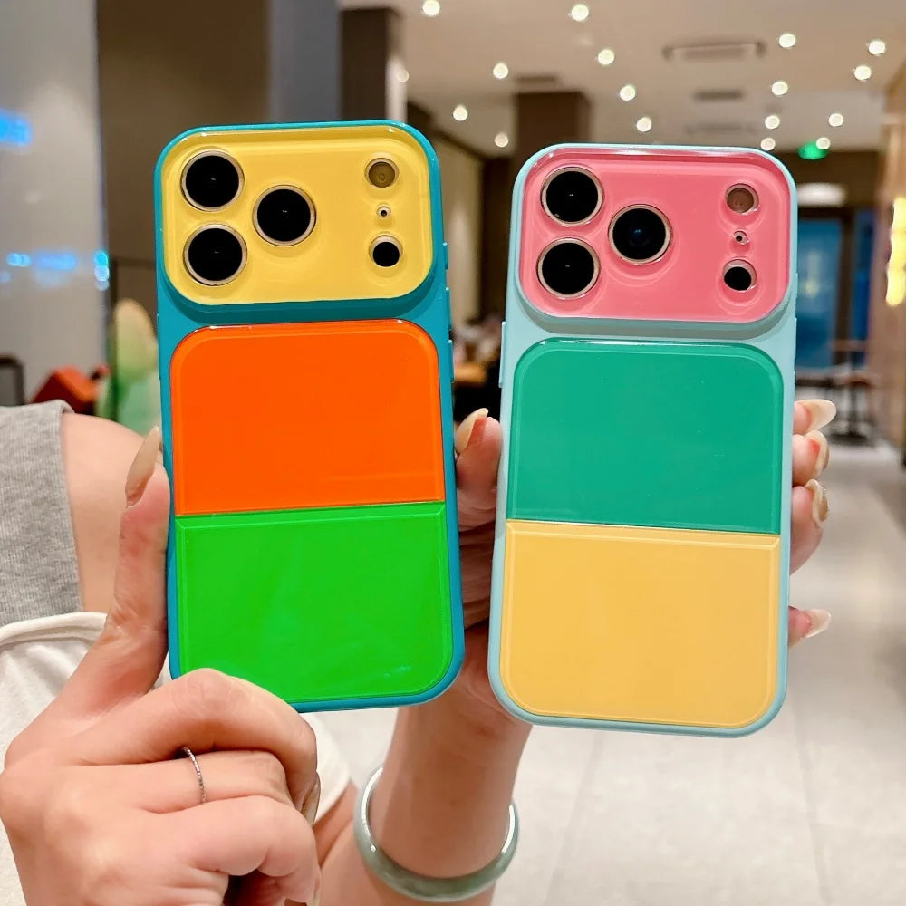 A hand holds a Dopamine multicolor block acrylic phone case for iPhone featuring vibrant green, orange, and yellow sections.