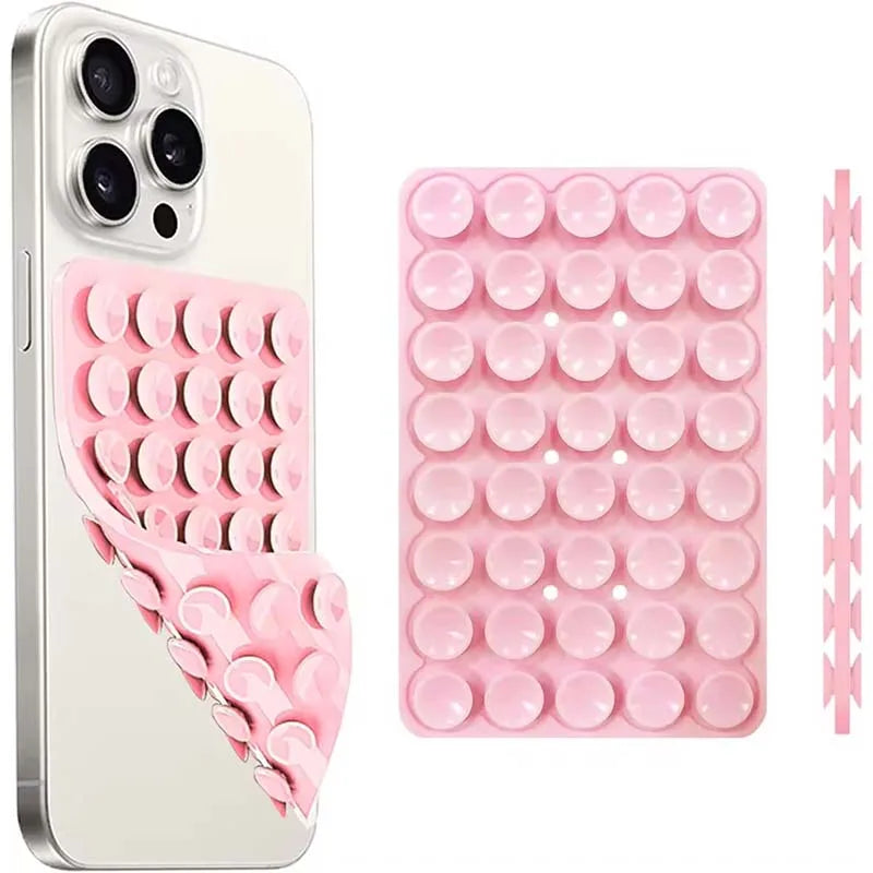 A double-sided silicone suction cup phone mount in pink, showing the phone case and a silicone grip pad.