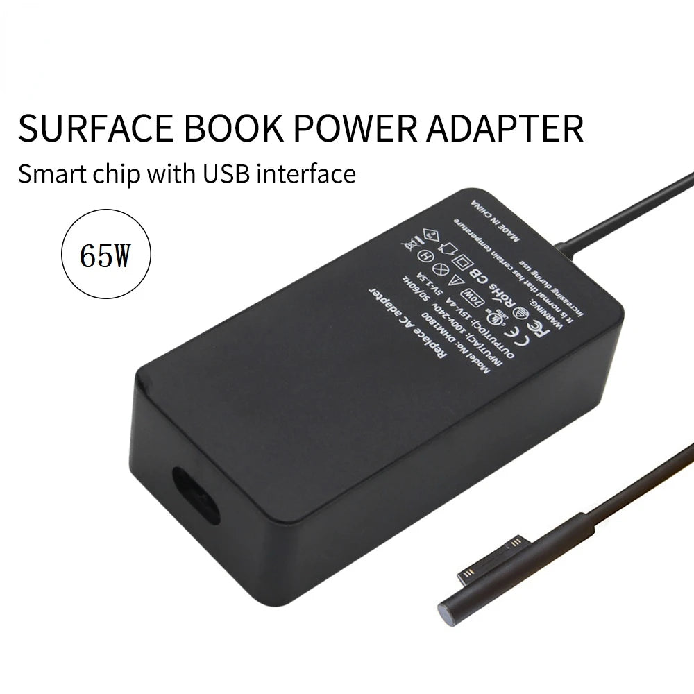A black surface book power adapter with a USB interface and a cable.