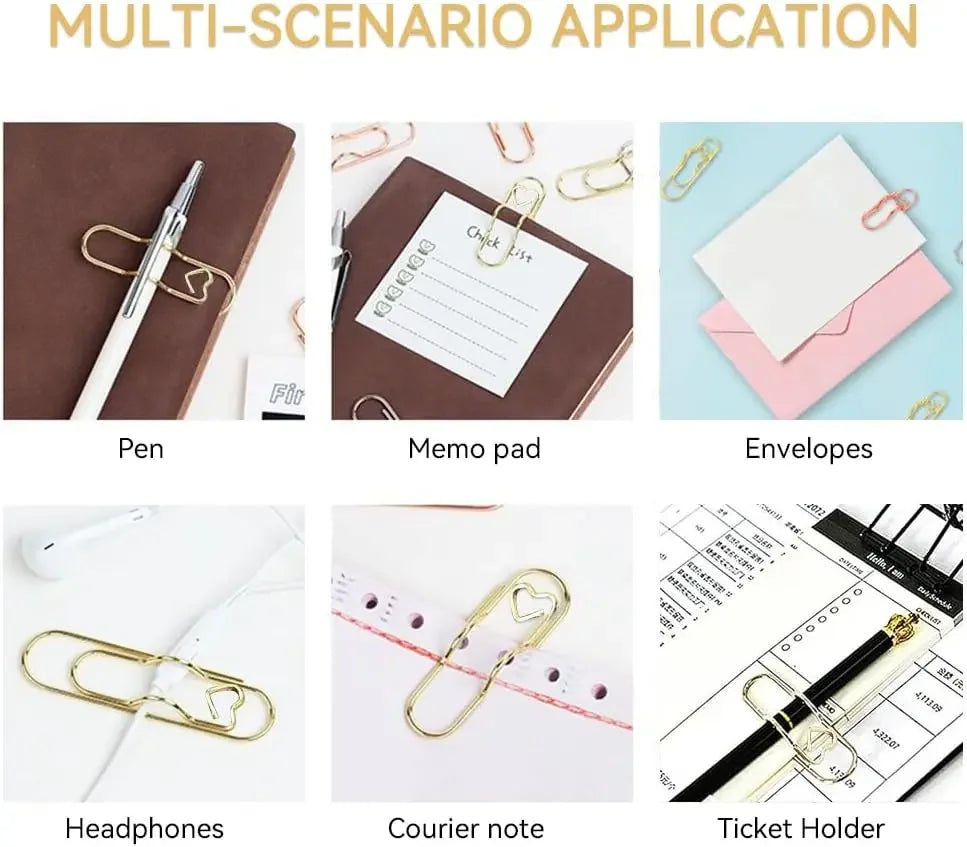 A collection of elegant metal pen clips, envelopes, a memo pad, headphones, and a ticket holder displayed on a wooden surface