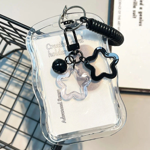 A clear card holder with a textured surface and a black keychain attached.
