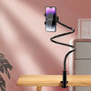 A black adjustable phone stand holding a smartphone in a vertical position on a wooden desk.