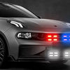 A silver Porsche sports car with red and blue LED lights illuminated on the front grille and bumper.