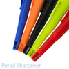 A close-up view of several colored pencil sharpeners, including blue, orange, black, lime green, and red.