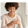 A woman is using a USB-C to USB 3.0 OTG adapter to read files from a USB storage device on her smartphone.