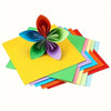 A colorful arrangement of cardstock sheets, including a large orange flower shape.