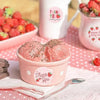 A pink cup of strawberry flavored ice cream with a thank you sticker design on the side