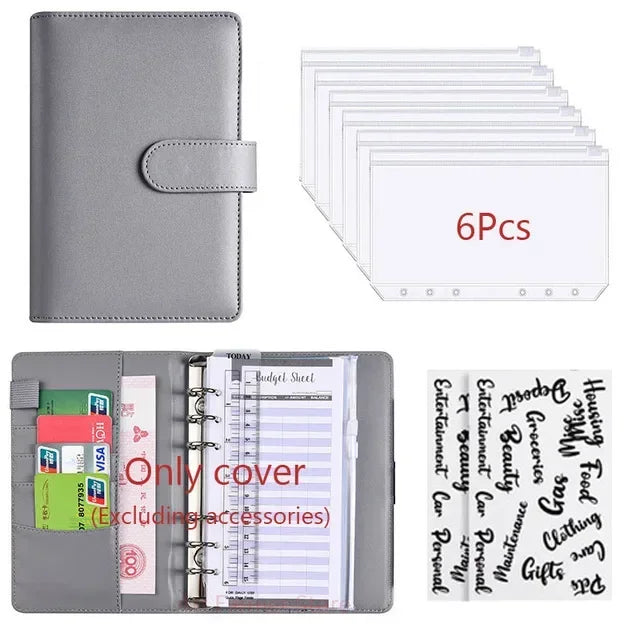 Planificador de cuero sintético gris con cubierta y varias hojas de papel.