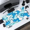 A blue and white wave pattern mouse pad is displayed on a desk next to a computer mouse and other accessories.