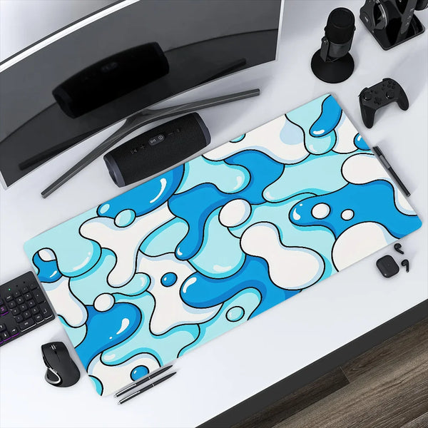 A blue and white wave pattern mouse pad is displayed on a desk next to a computer mouse and other accessories.