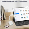 حاسوب محمول يعرض واجهة لإدارة الملفات بجانب قارئ بطاقة USB-C أبيض وكتب على مكتب خشبي.