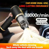 A hand is using a black and gold portable dual-use vacuum cleaner to clean a surface.