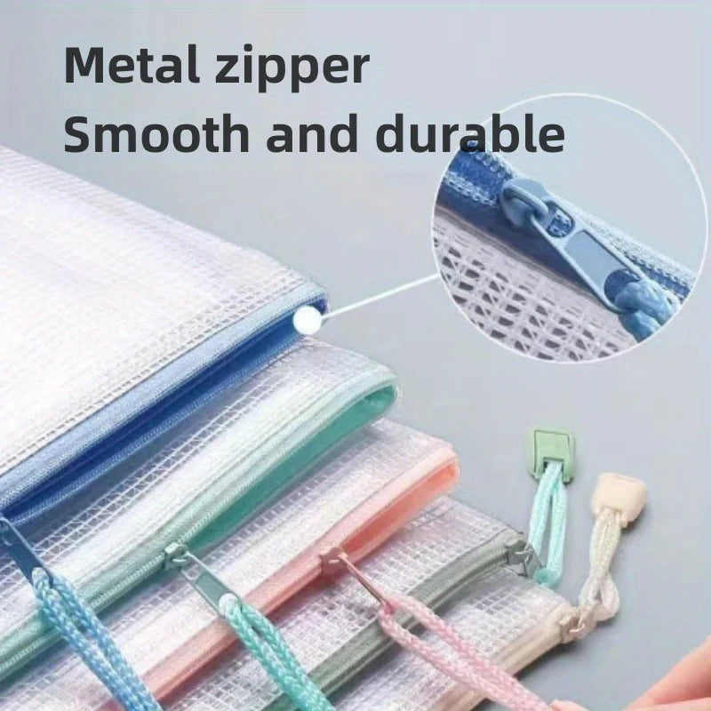 Close-up of mesh zipper bags in various colors stacked together showing the metal zipper detail.