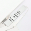 A white silver stainless steel bookmark with a white tassel attached to a card.