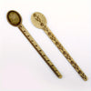 Vintage brass straight ruler with a minimalist design featuring engraved floral patterns.