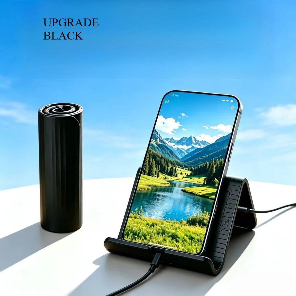 A black flexible silicone phone stand is shown next to a black cylindrical battery, with a smartphone displaying a scenic lan