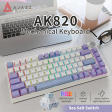 A close-up view of an AK820 mechanical keyboard with purple switches and RGB backlight, shown next to a laptop.