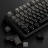 A close-up view of a black mechanical keyboard with gradient gray double shot PBT keycaps and side printing, showing various 