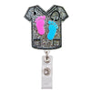 A glittery badge reel holder featuring pink and blue footprints on a black shirt design.