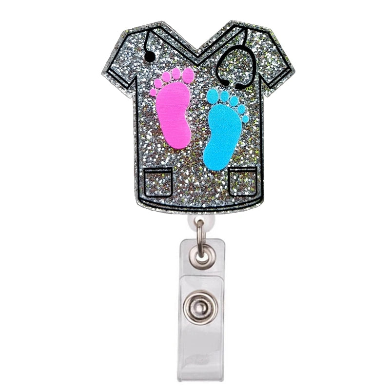 A glittery badge reel holder featuring pink and blue footprints on a black shirt design.