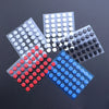 A collection of adhesive glide feet in various colors, including white, black, and red, arranged in a starburst pattern.