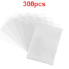 A stack of clear protective sleeves for trading cards, showing various translucent plastic sheets.