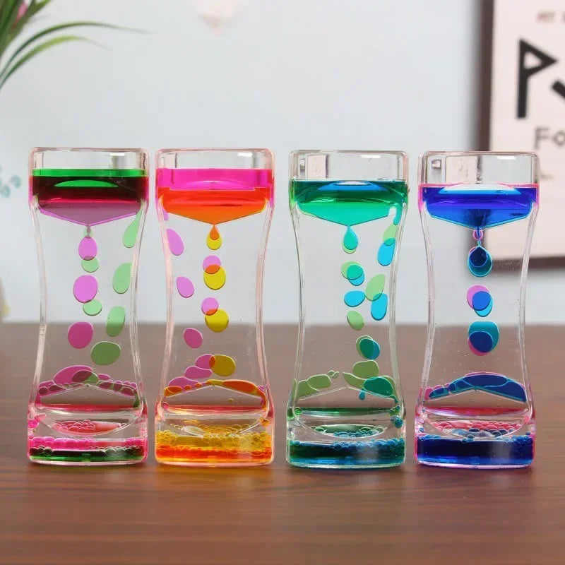 A row of glass hourglass timers filled with colorful liquids, demonstrating various colors and patterns.