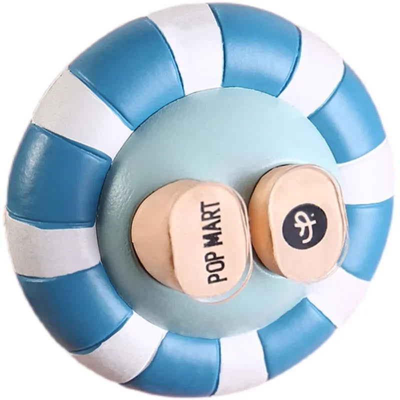 A round adhesive fixer pad with blue and white stripes, featuring a circular center and a small circular stamp.