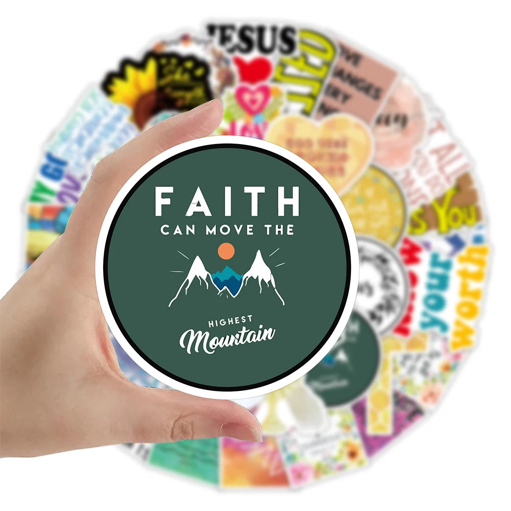 A hand holds a circular arrangement of inspirational Bible verse stickers featuring mountains and hearts.