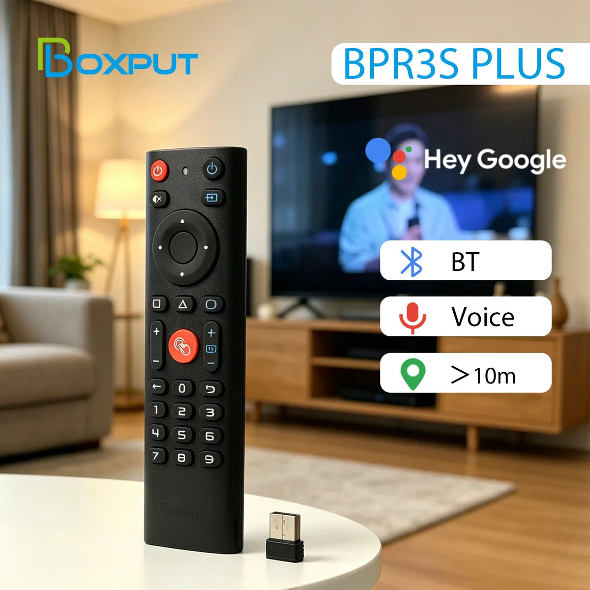 Black wireless gyro air mouse remote with BT and voice control features displayed on a coffee table.