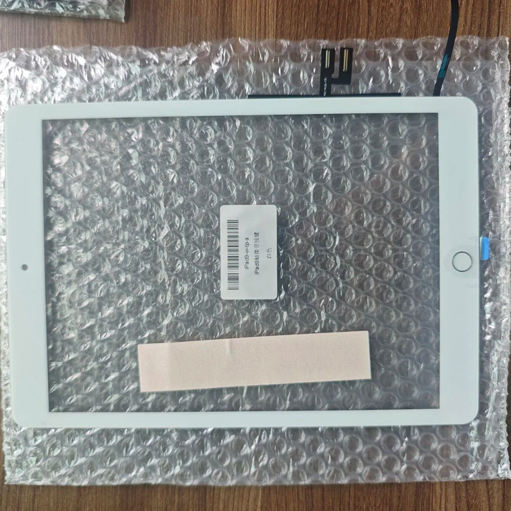 A white iPad screen is shown on a clear plastic sheet with a small card and a pink piece of paper.
