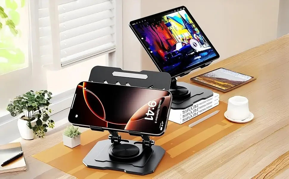 An adjustable dual rod tablet and phone stand holding a smartphone and a laptop on a wooden desk.