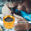 A close-up of an elderly person using a gold watch repair loupe to examine a watch component.