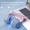 Pink and blue gradient RGB cat ear Bluetooth headphones resting on a white laptop.
